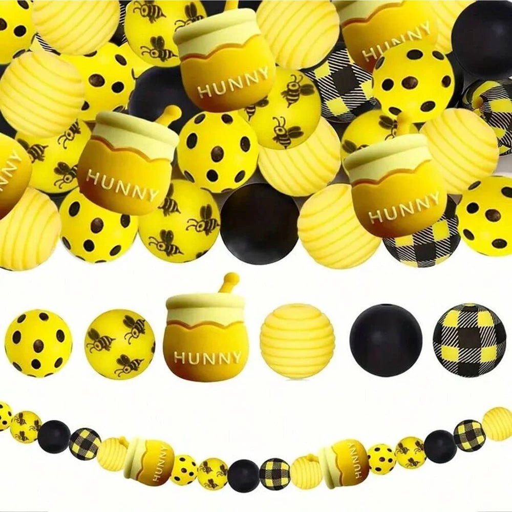 A collection of yellow and black silicone beads shaped like bees for jewelry making and DIY crafts