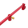 A red aluminum circle drawing ruler and center finder for woodworking with a brass finder tip.