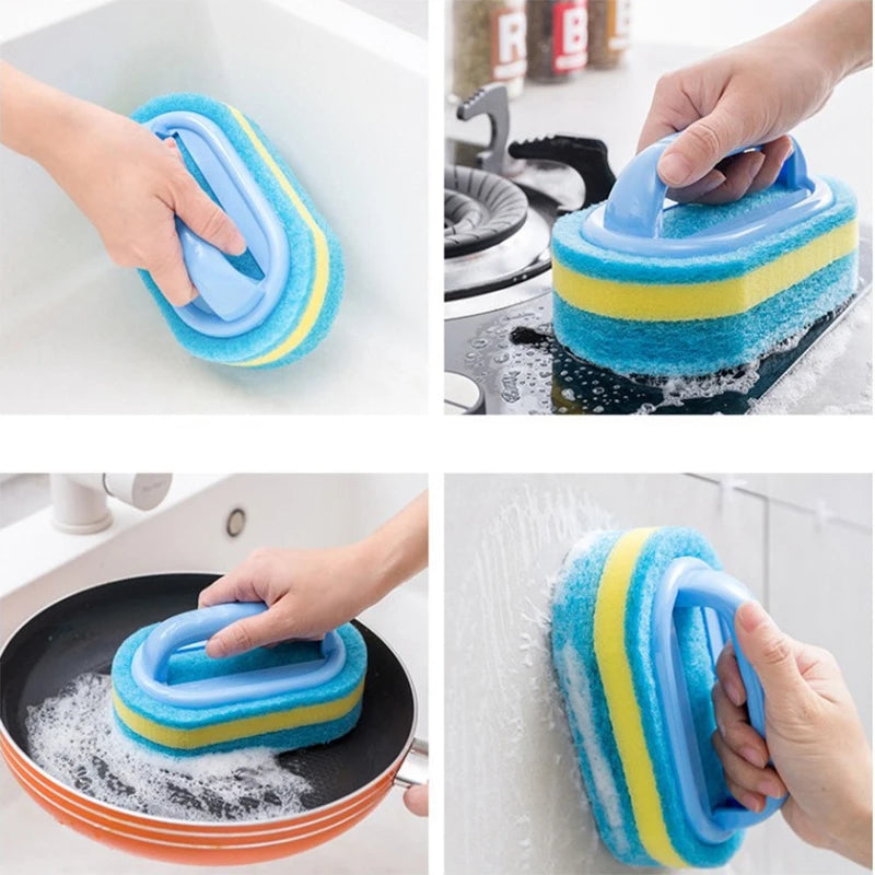 A hand is using a blue and yellow sponge cleaning brush to clean a sink and a frying pan.