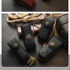 A set of handcrafted genuine leather folding knife cases in dark brown and black with gold accents