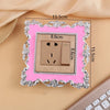 A rectangular switch cover frame with a rose pattern border and brass finish, shown against a light background.