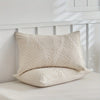 A cream-colored microfiber duvet cover featuring an embossed leaf pattern resting on a white surface.