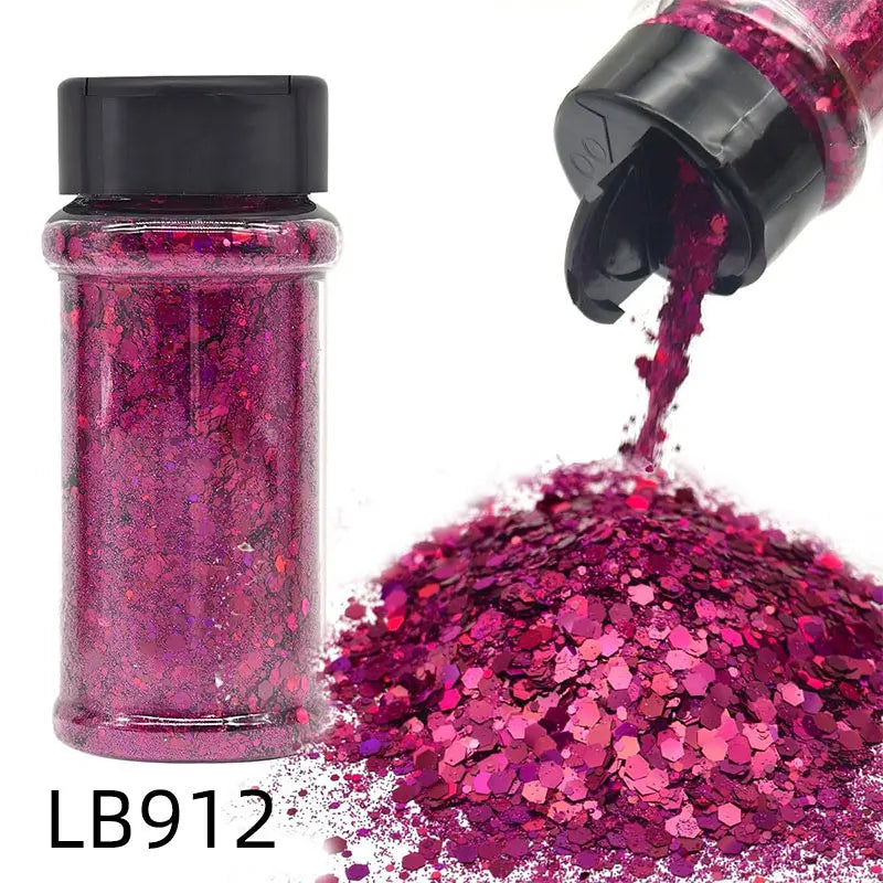 A glass jar of pink glitter and a pile of loose holographic chunky nail glitter mix.