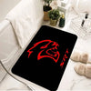 A black silicone mat with a red stylized lion head design is placed on a white marble surface.