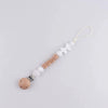 A personalized silicone pacifier clip with a name and anti-drop lanyard on a white background.