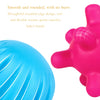A close-up of a pink Montessori rainbow grasping ball with rounded edges and a textured surface.