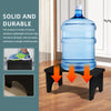 A clear plastic water bottle is placed on a black stool, demonstrating the solid and durable bamboo toilet squat stool.