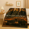 A dark blanket featuring characters and a classic car, inspired by the Supernatural TV show.