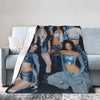 A creative microfiber fleece throw blanket draped over a gray sofa, featuring a collage of models.