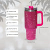 A pink rhinestone bling tumbler with a straw and handle, showing various features like stainless steel construction and vacuu