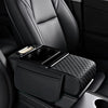 Black car armrest cushion with textured cover and integrated cupholders and storage.