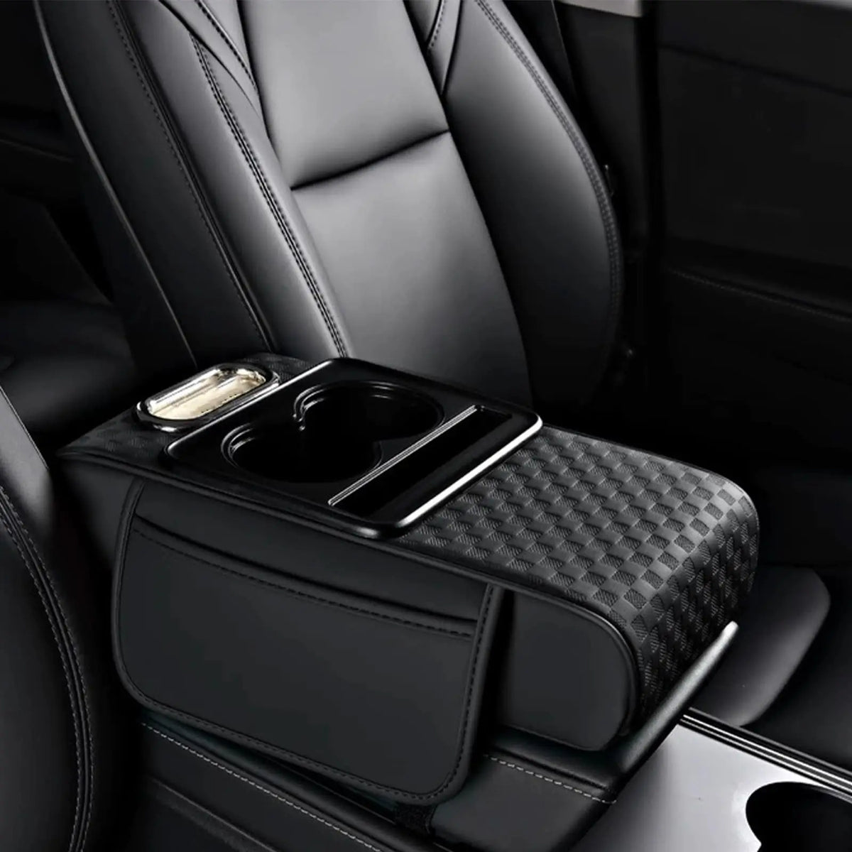 Black car armrest cushion with textured cover and integrated cupholders and storage.