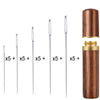 A set of large eye sewing needles with five sizes stored in a wooden cylindrical case.