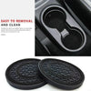 A set of two black non-slip silicone car cup holder coasters shown next to a close-up of the product being used in a car cup 
