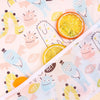 A close-up of colorful waterproof long-sleeve baby bibs featuring cute face designs and citrus slices.