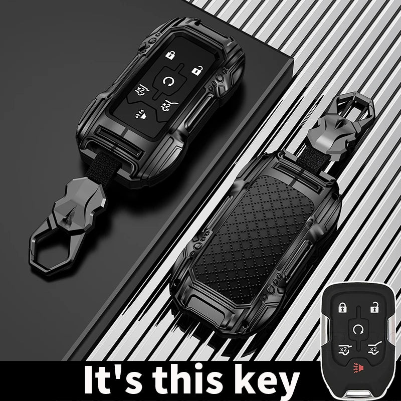 A black zinc alloy key fob case for a Chevy Silverado or GMC Sierra truck is shown with its attached key.