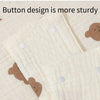 Close-up of a light beige stroller cover fabric showing button designs and stitching details.