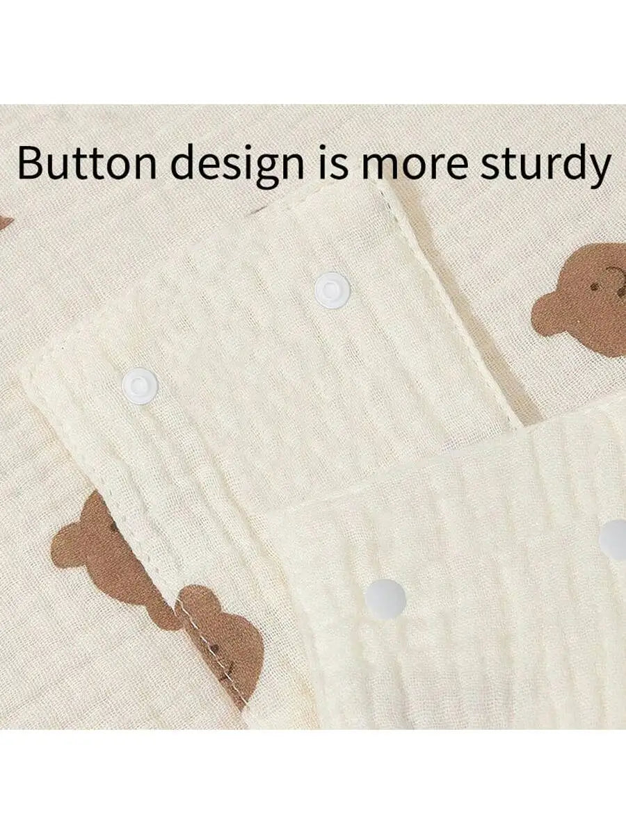 Close-up of a light beige stroller cover fabric showing button designs and stitching details.
