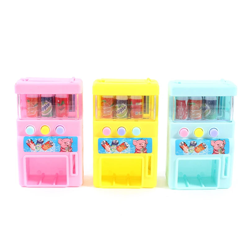 Three colorful interactive vending machine toys in pink, yellow, and blue with play coins and drinks.