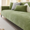 A light green chenille sofa cover with gray and lime green accent pillows on a white sofa.