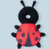 A black and red toddler head protector backpack shaped like a ladybug.