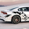 A white sports car features black wolf decals on the side, parked outdoors against a pale sky.