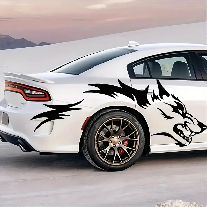 A white sports car features black wolf decals on the side, parked outdoors against a pale sky.