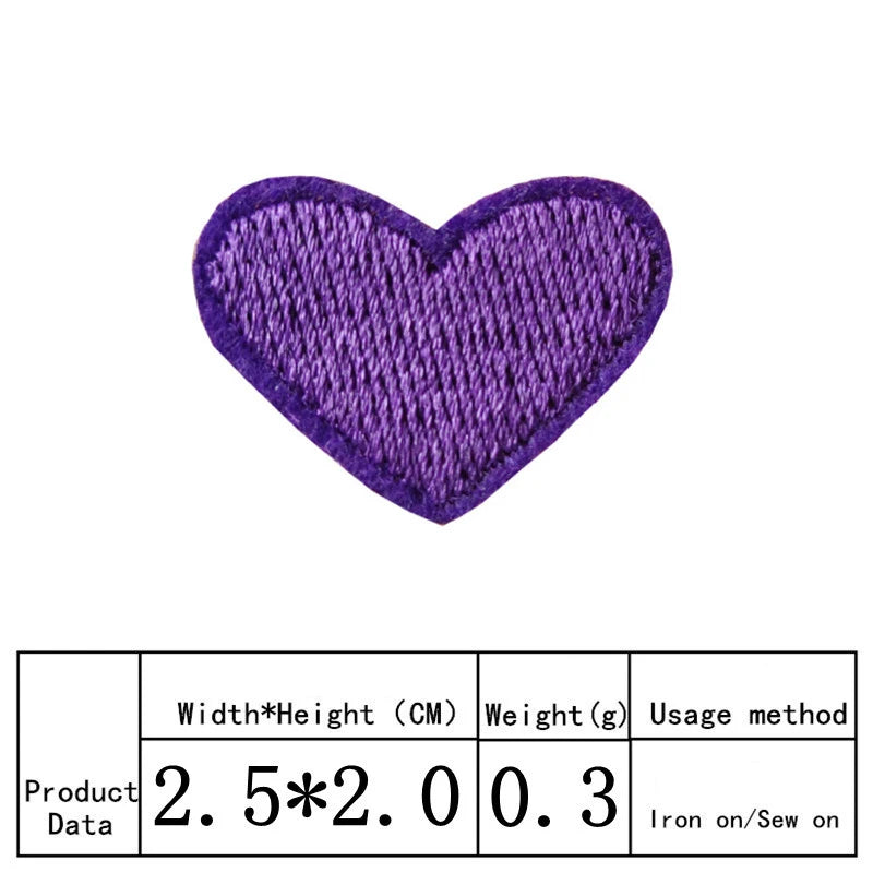 A purple heart shaped embroidery patch used for iron-on application.