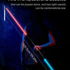 A glowing pink and blue lightsaber is held by a person against a dark background.