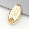 A gold and white TPU car key case cover with a button and a round indentation.