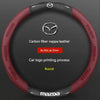 A round red carbon fiber leather steering wheel cover for a Mazda vehicle.