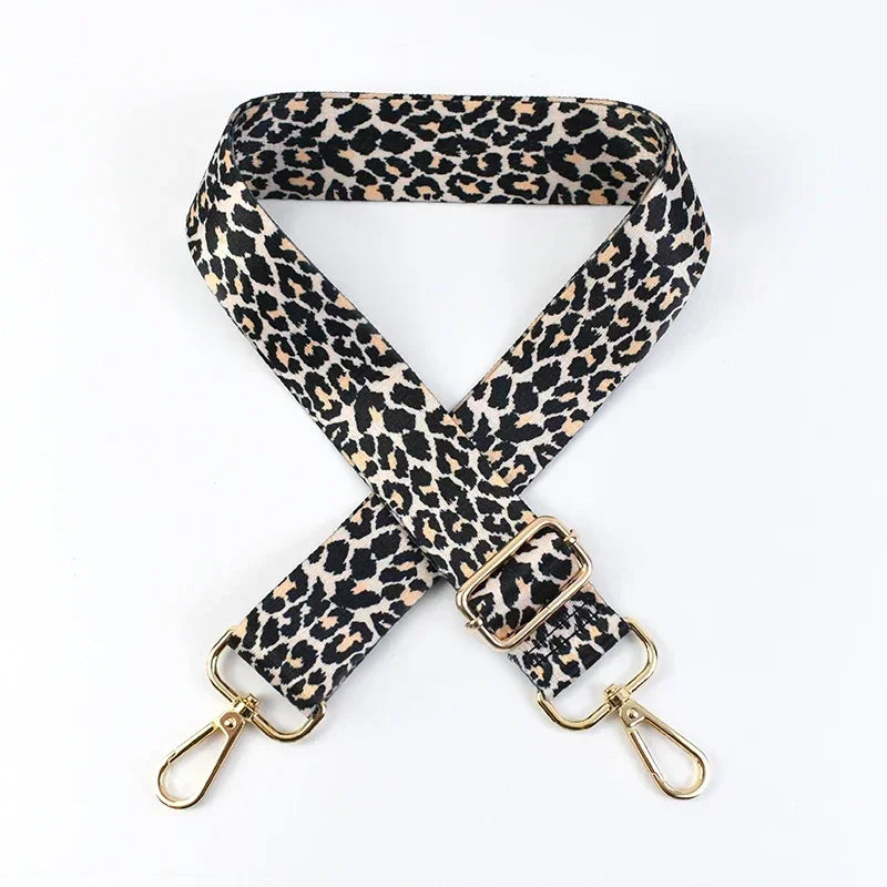 A black and tan leopard print wide adjustable crossbody bag strap.