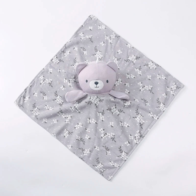 A gray baby comforter featuring a cute stuffed bear design with small white floral patterns.
