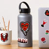 A silver water bottle featuring a black and red gothic skull design.