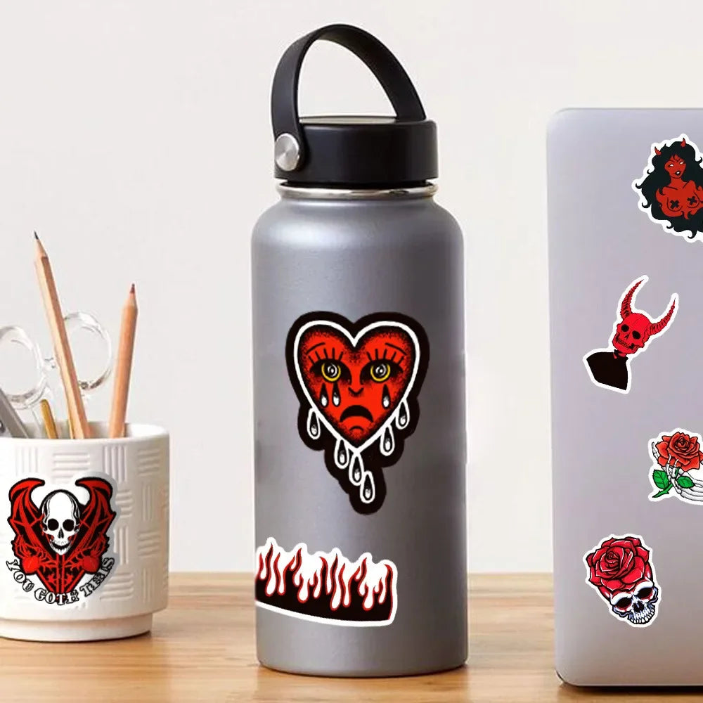 A silver water bottle featuring a black and red gothic skull design.