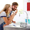 A woman is using an EVA travel case for a toothbrush with a protective shell in a bathroom sink.