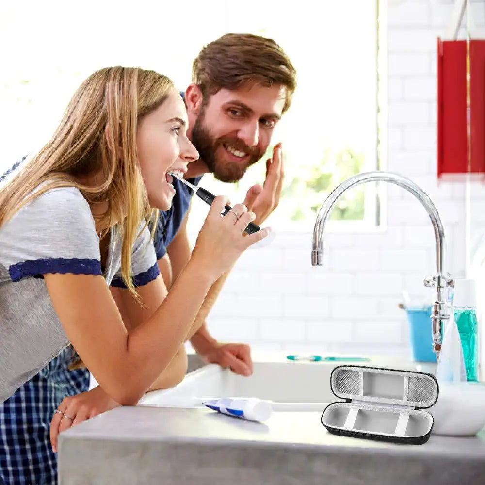 A woman is using an EVA travel case for a toothbrush with a protective shell in a bathroom sink.