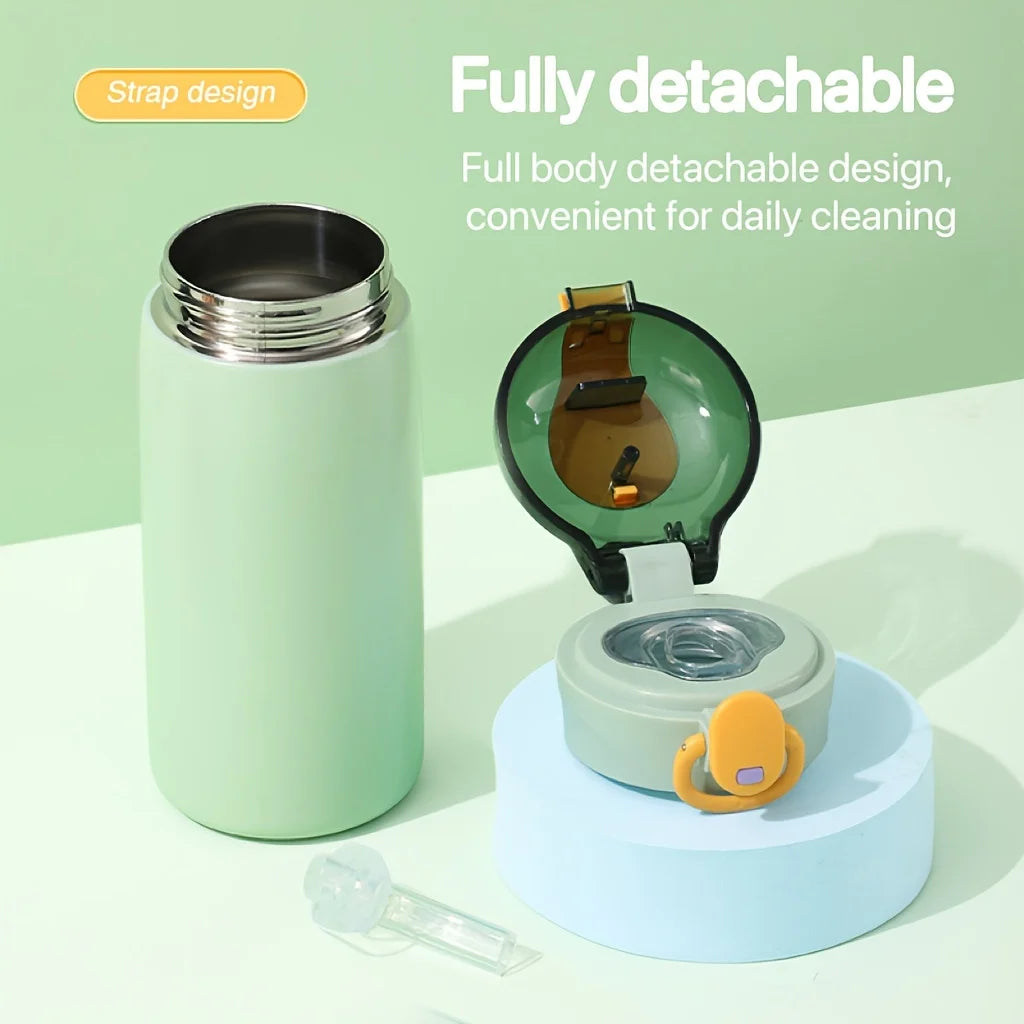 A light green insulated water bottle with a detachable body and a pop-up straw lid resting on a blue stand.