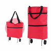 A bright red foldable rolling shopping bag with black handles and wheels.
