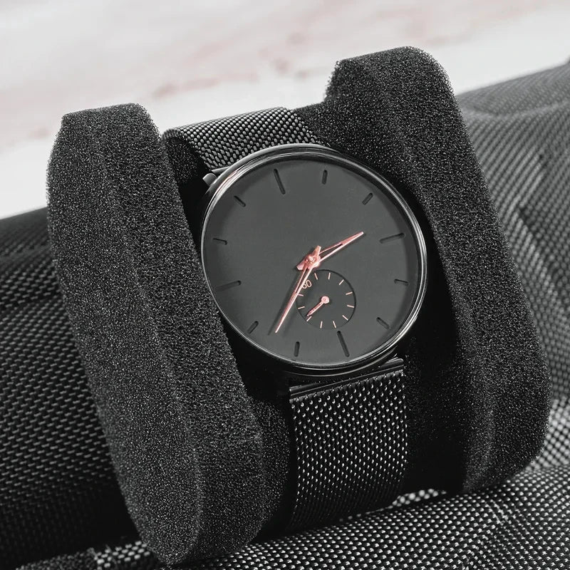 A black portable leather watch is shown inside a padded travel case with soft lining.