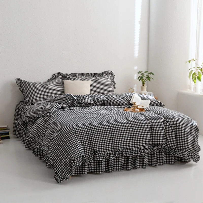 A black and white plaid duvet cover set with matching pillowcases displayed on a bed.