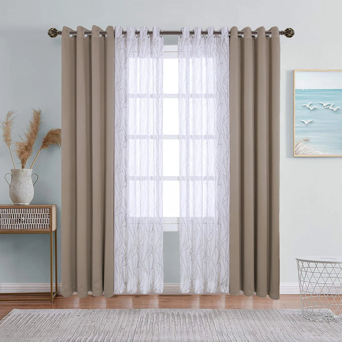Dual layer window curtains featuring a sheer white layer and a solid taupe blackout layer hanging over a window.