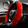 A red and gray plush steering wheel cover is shown inside a car's interior.