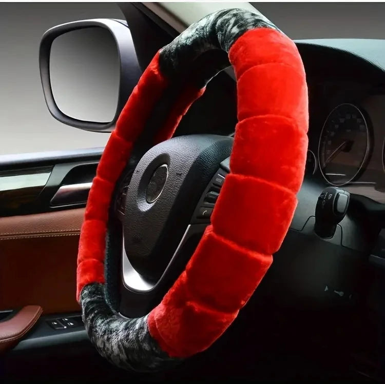 A red and gray plush steering wheel cover is shown inside a car's interior.
