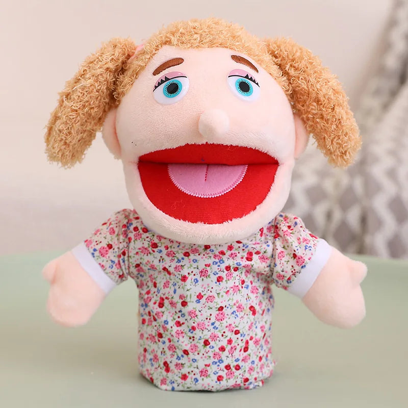 A soft plush hand puppet with light brown hair and a red mouth, wearing a floral patterned shirt.