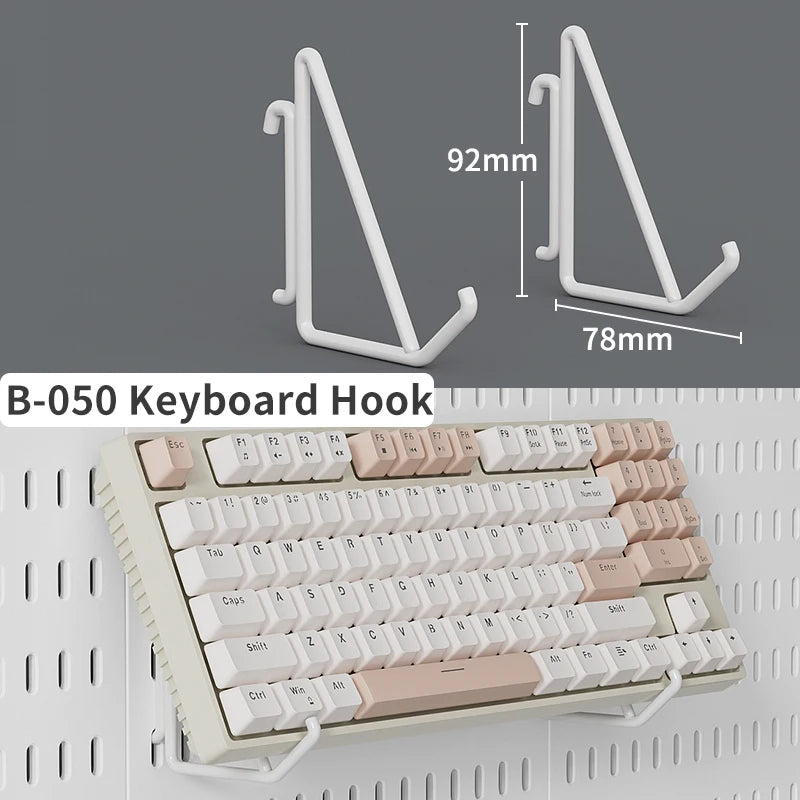 A white keyboard hook shown alongside a full pink and white mechanical keyboard.