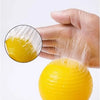 A hand is squeezing a yellow, high-viscosity insect adhesive ball, demonstrating its sticky properties.