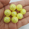 A handful of bright yellow translucent acrylic beads for jewelry making