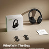 A box and black over-ear headphones are displayed on a beige surface with accessories.