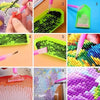 A set of diamond painting accessories including a pen applicator and various colored beads on a grid board.